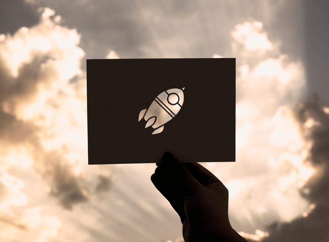 hand-hold-space-rocket-paper-carving-with-sky-background_53876-30288.jpg